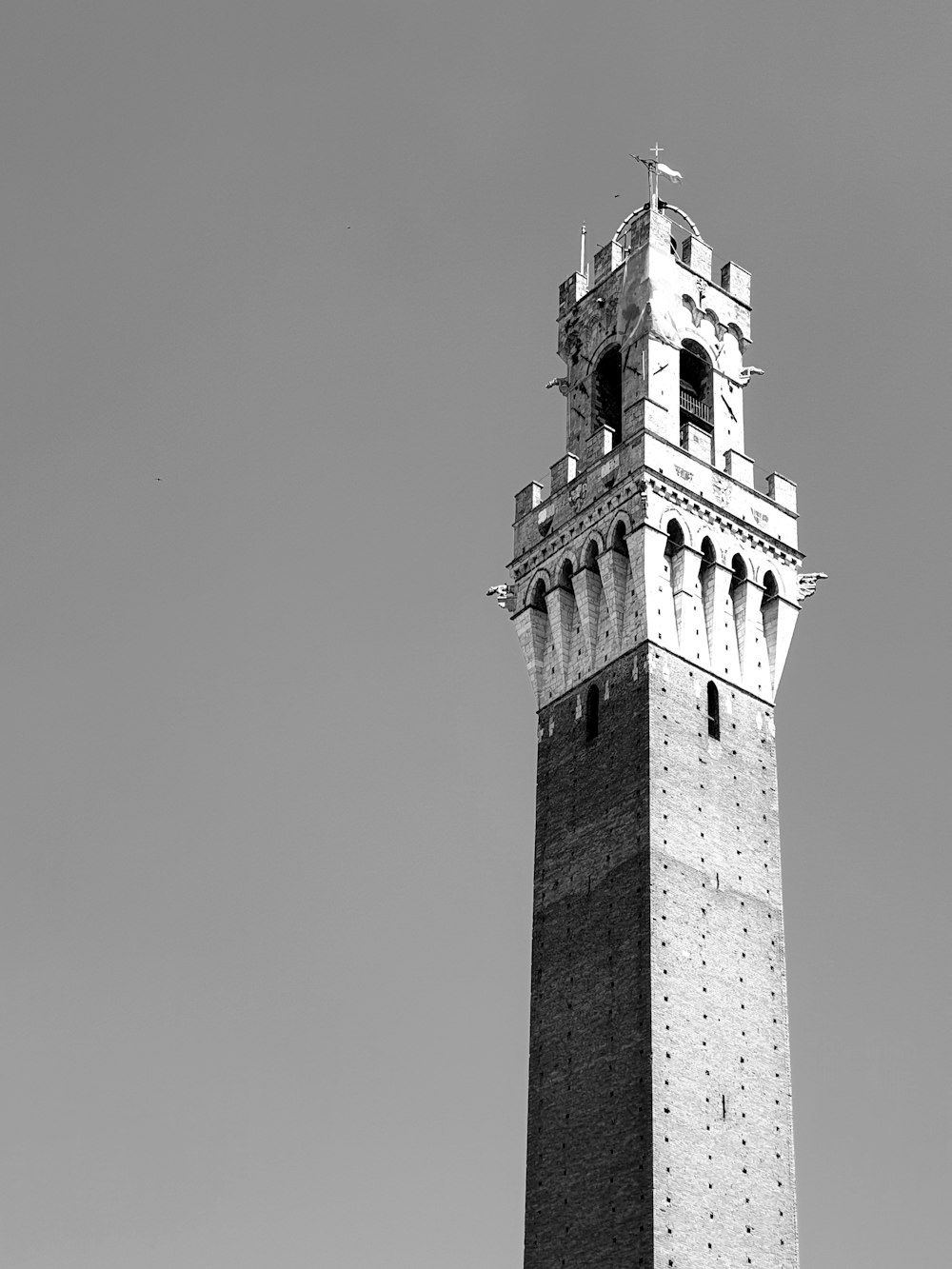 a tall tower with a cross on top