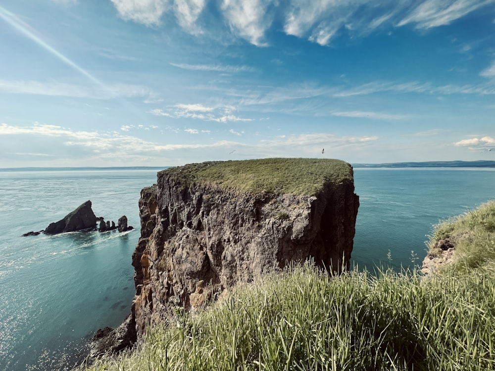 a cliff with a body of water below