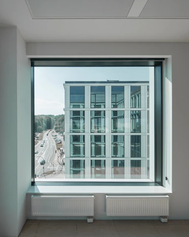 Modern office building with integrated smart climate control systems visible through glass walls