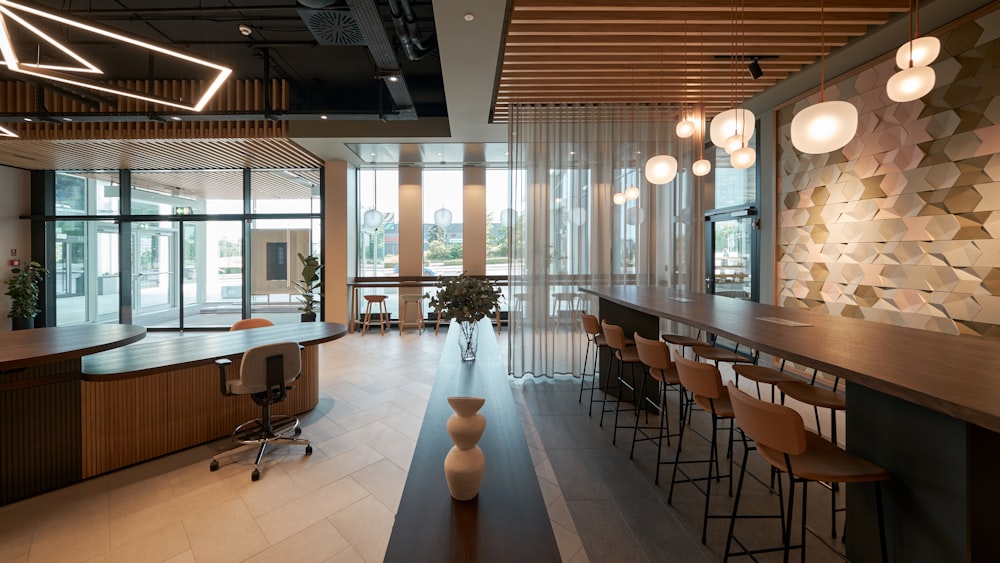 a large room with a bar and chairs