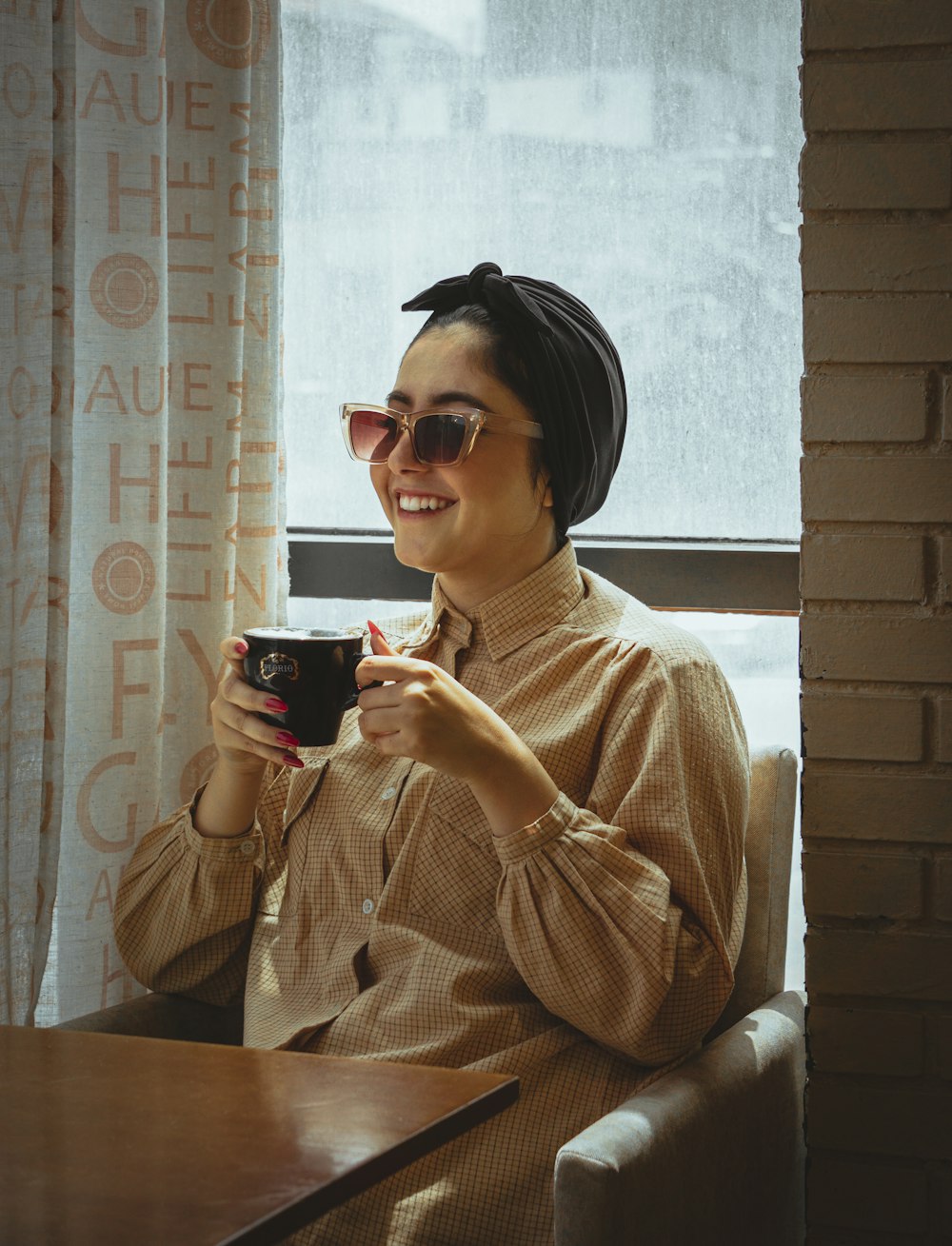 a person wearing headphones and holding a cup of coffee