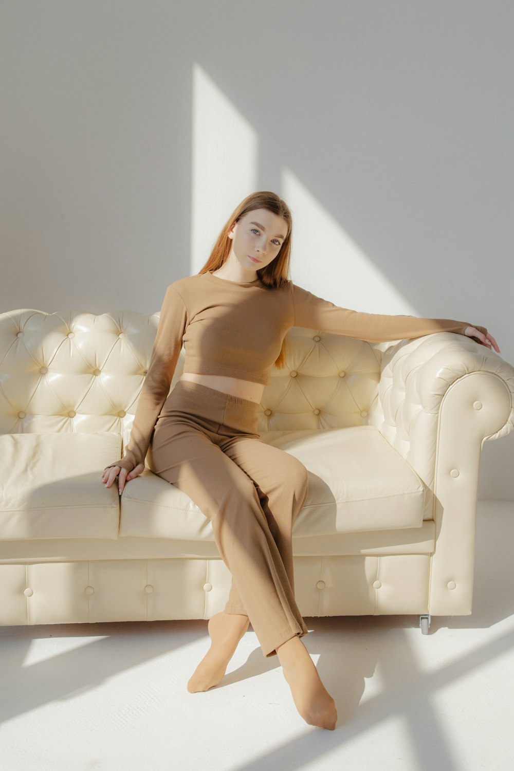 a person posing in front of a couch