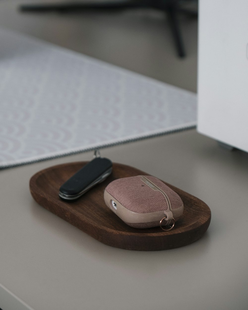 a leather wallet with a key on a white surface