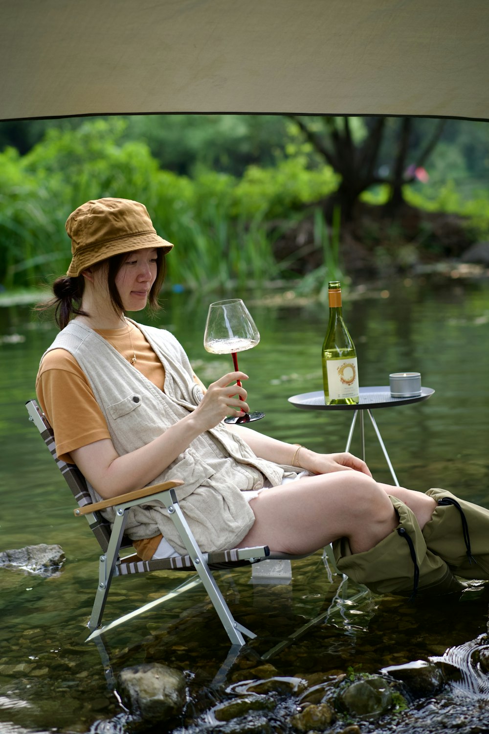 a woman sitting in a chair holding a glass of wine