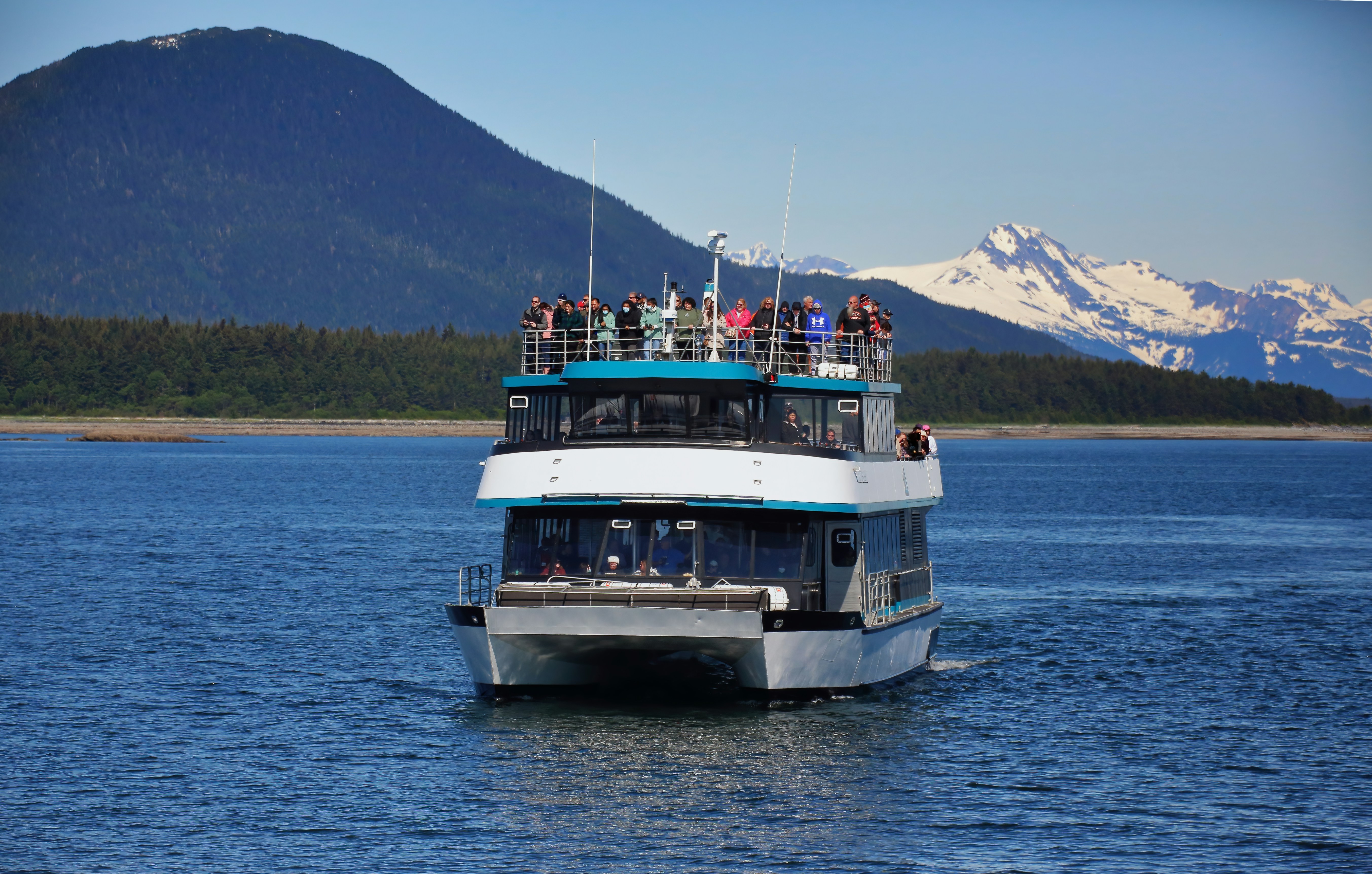 a boat full of people sailing on water, Whale watchers