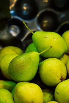 Close-up of fresh pears arranged in wooden crates at a farm.