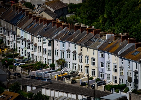 a group of buildings with trees in the background