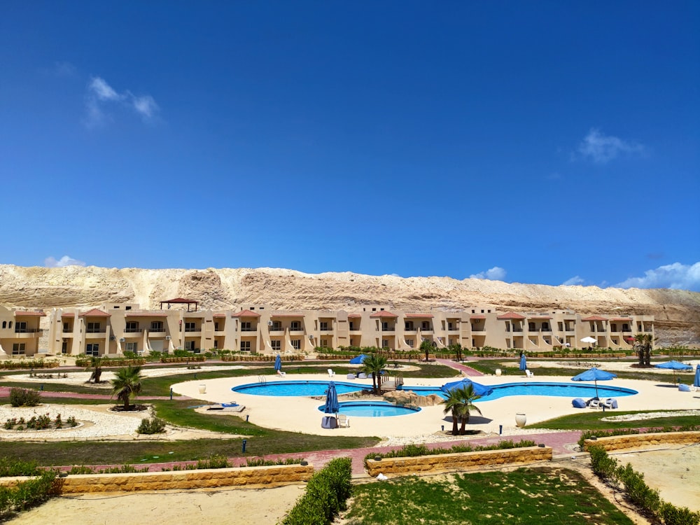 a large building with a pool in front of it