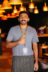 a man wearing a hat and a lanyard