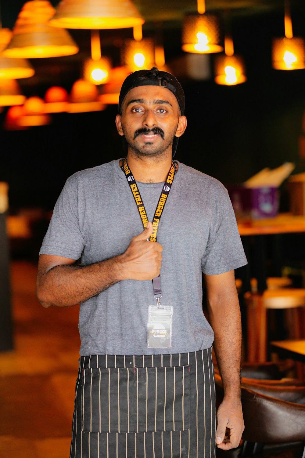 a man wearing a hat and a lanyard