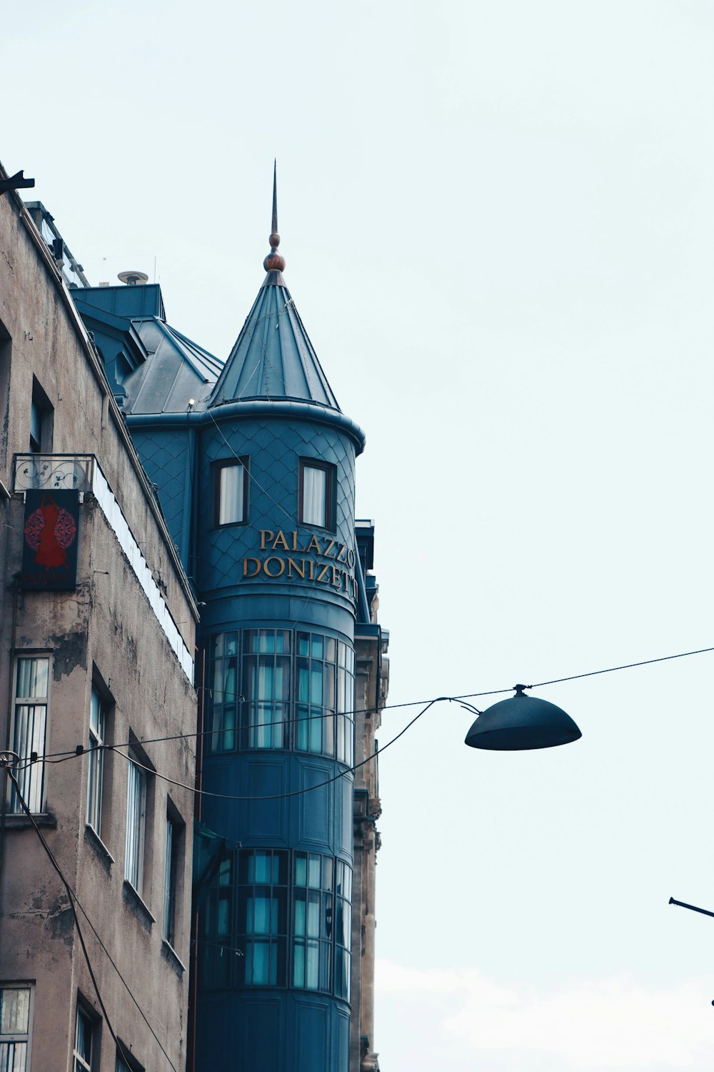 a tall building with a blue roof