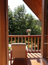 Balcony overlooking the garden with cozy chairs for morning coffee.