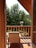A cozy villa balcony overlooking a lush garden with vibrant flowers.