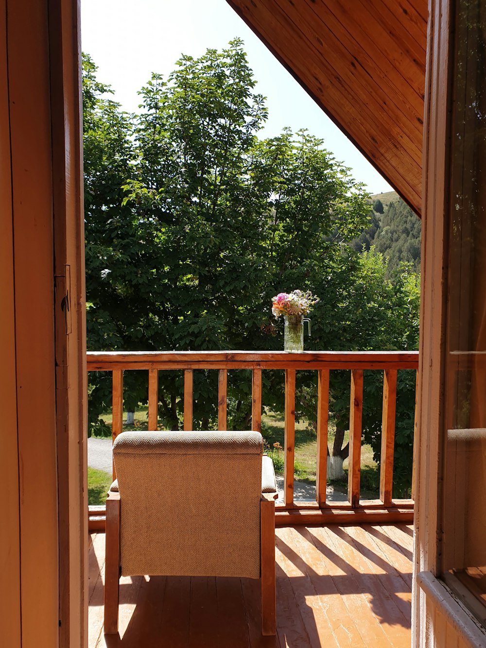 a chair and a vase on a porch