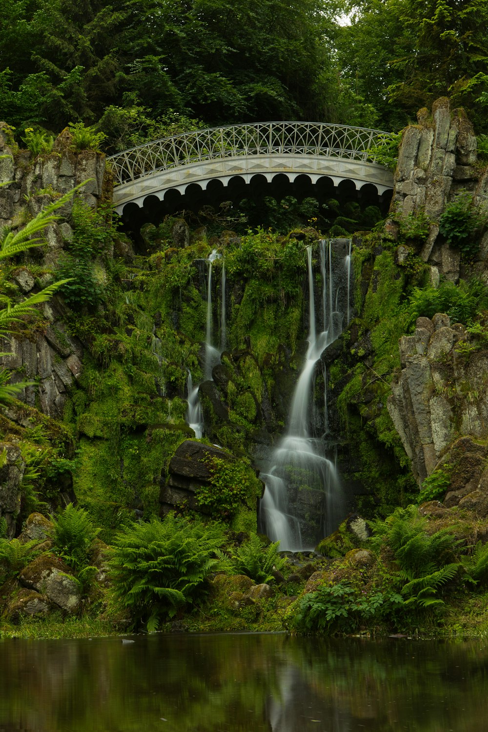 a bridge over a waterfall