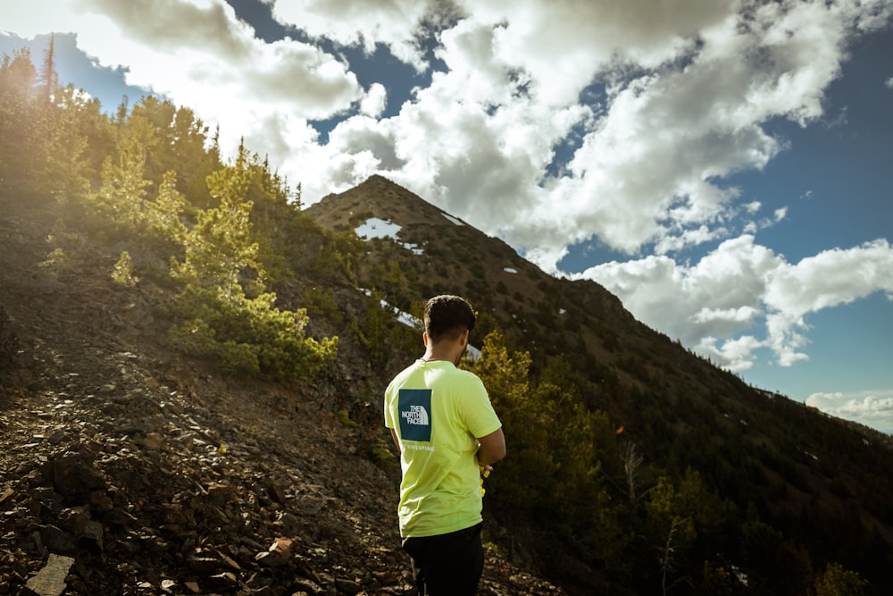 a man standing on a rocky hillside