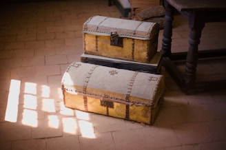 a couple of large wooden chests on a tile floor