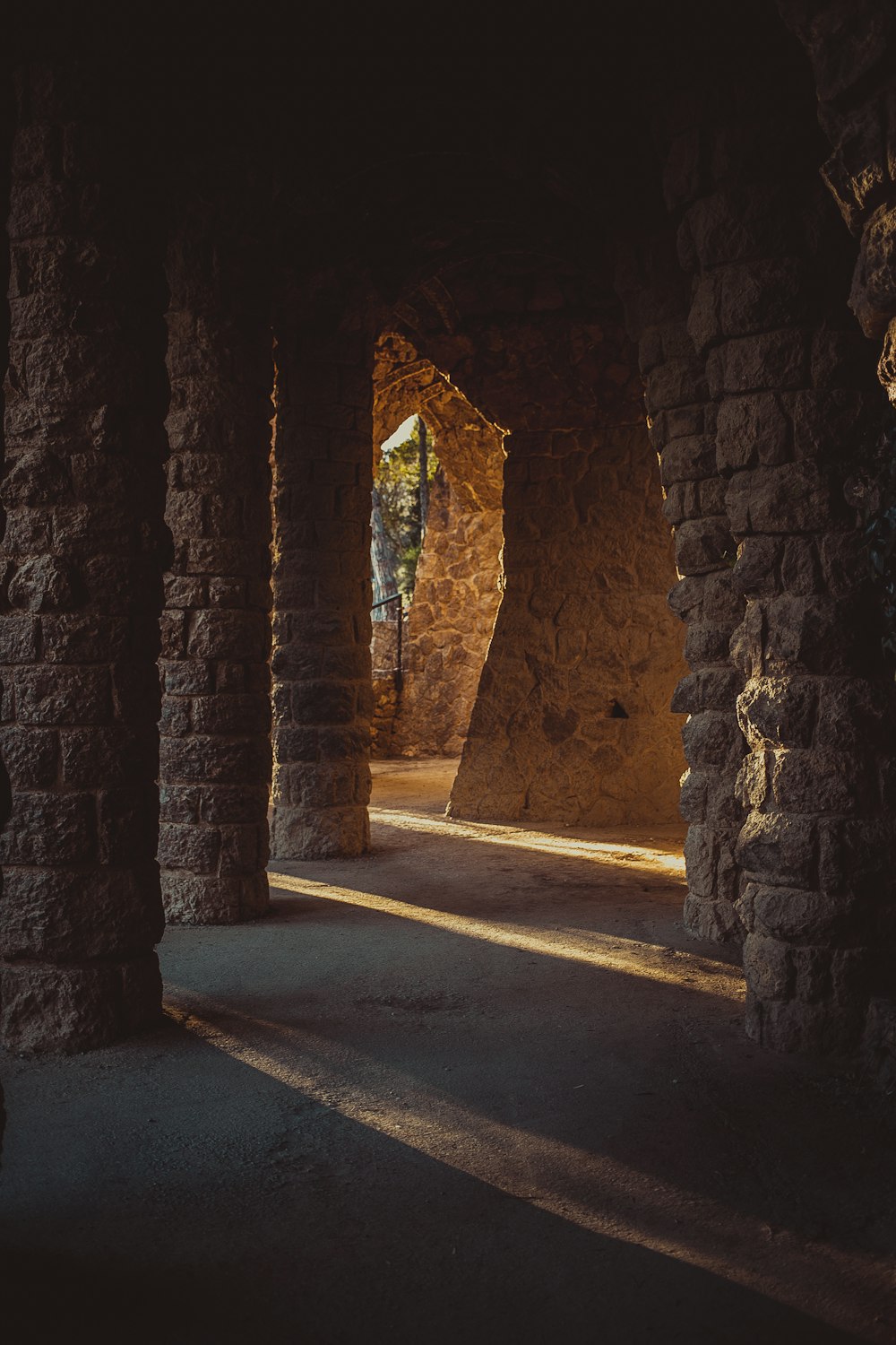 a stone tunnel with a road