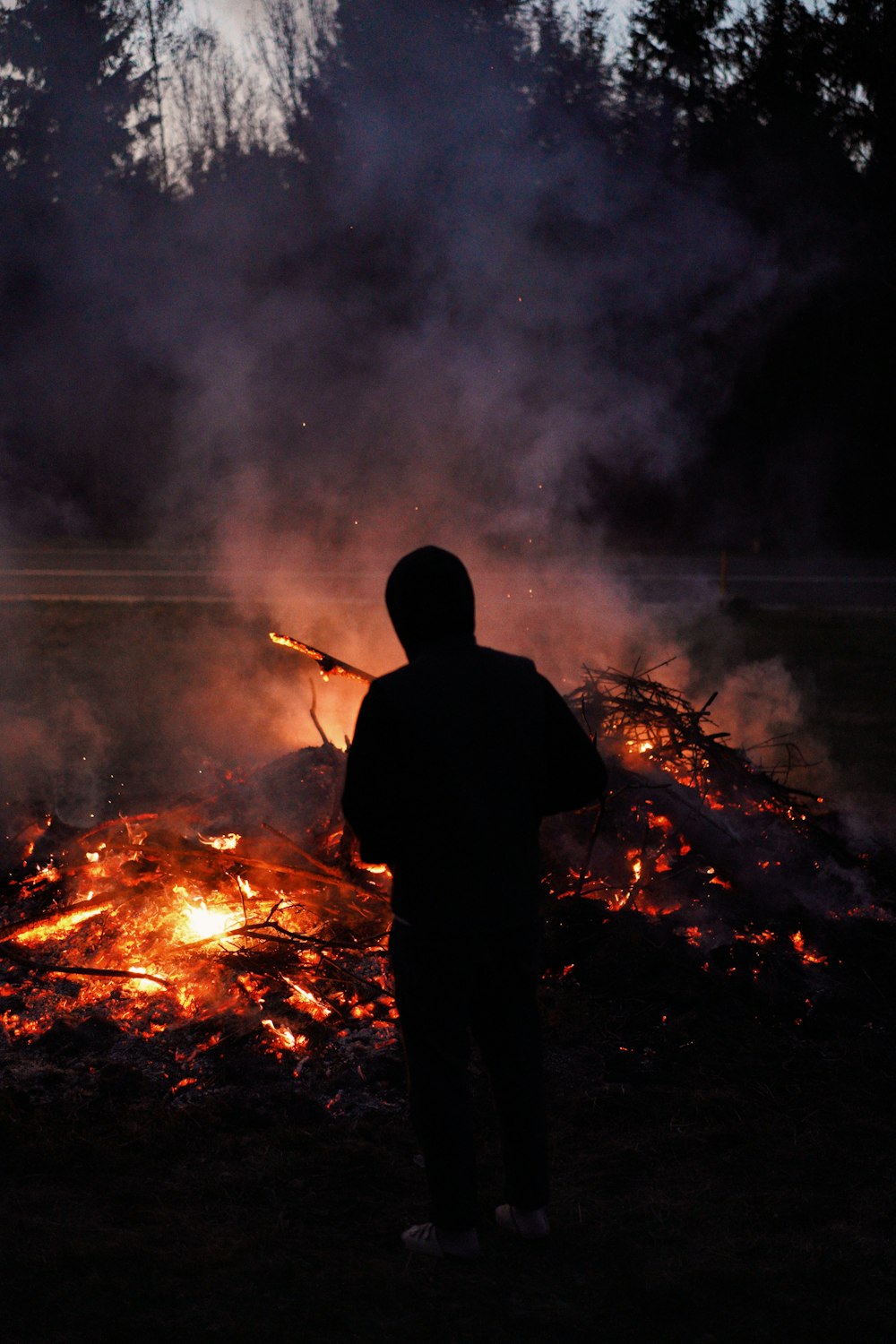 a person standing in front of a fire