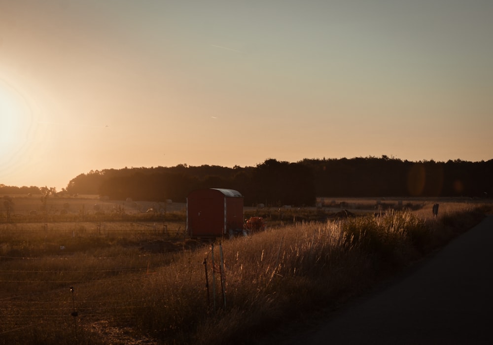 a field with a shed in it