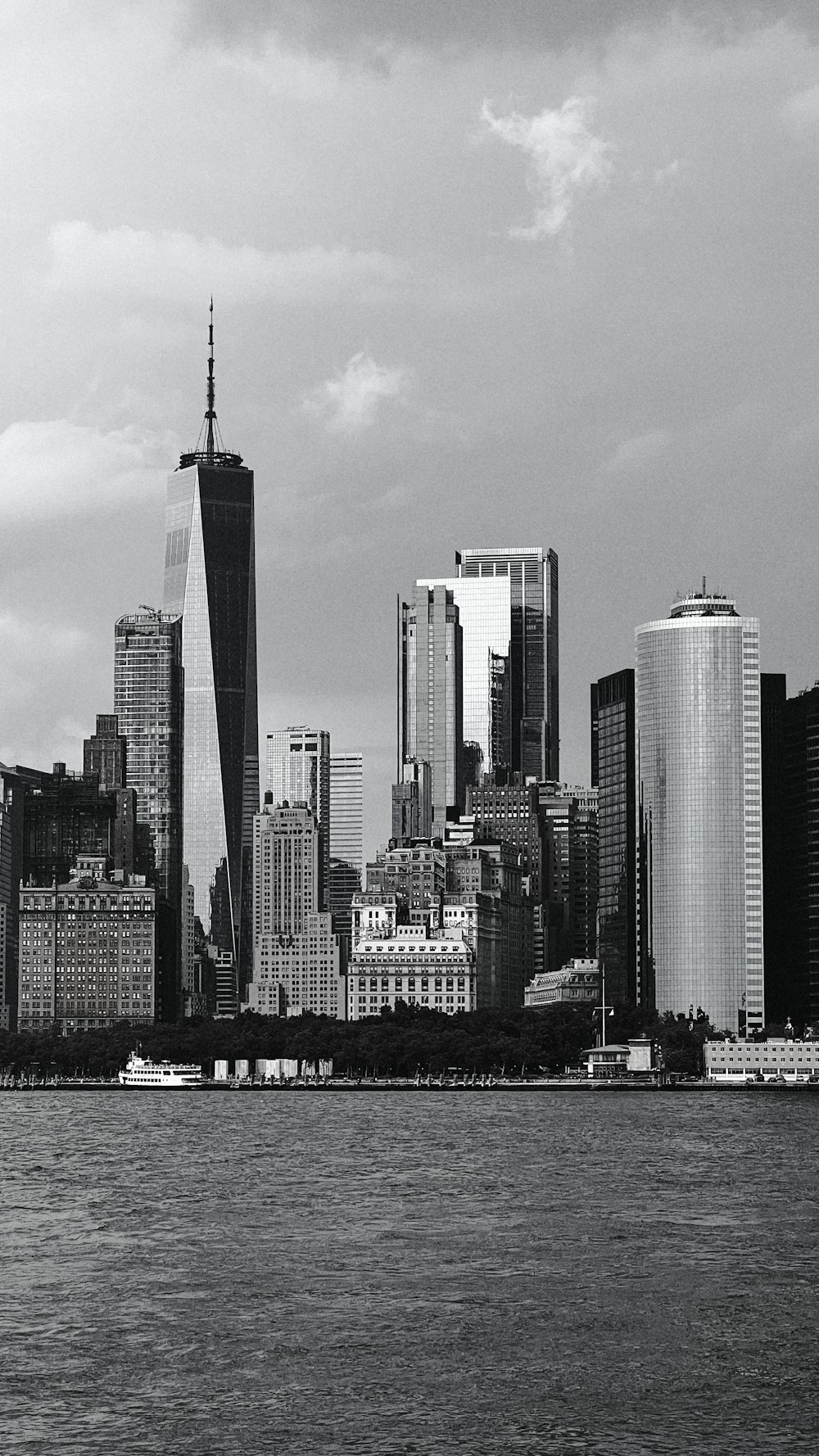 a city skyline with a body of water in the foreground