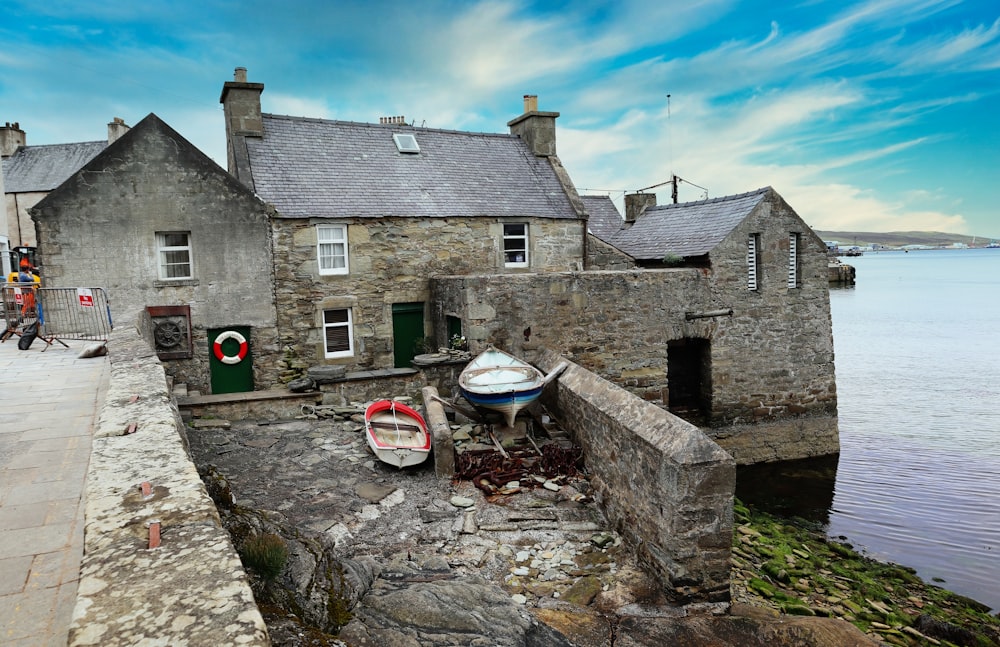 a stone building next to a body of water