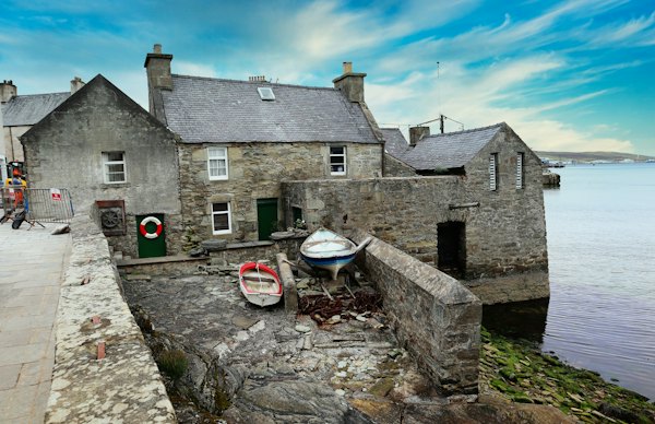 The Lodberrie, a stone house built out into the harbour at Lerwick — Shetland, United Kingdom