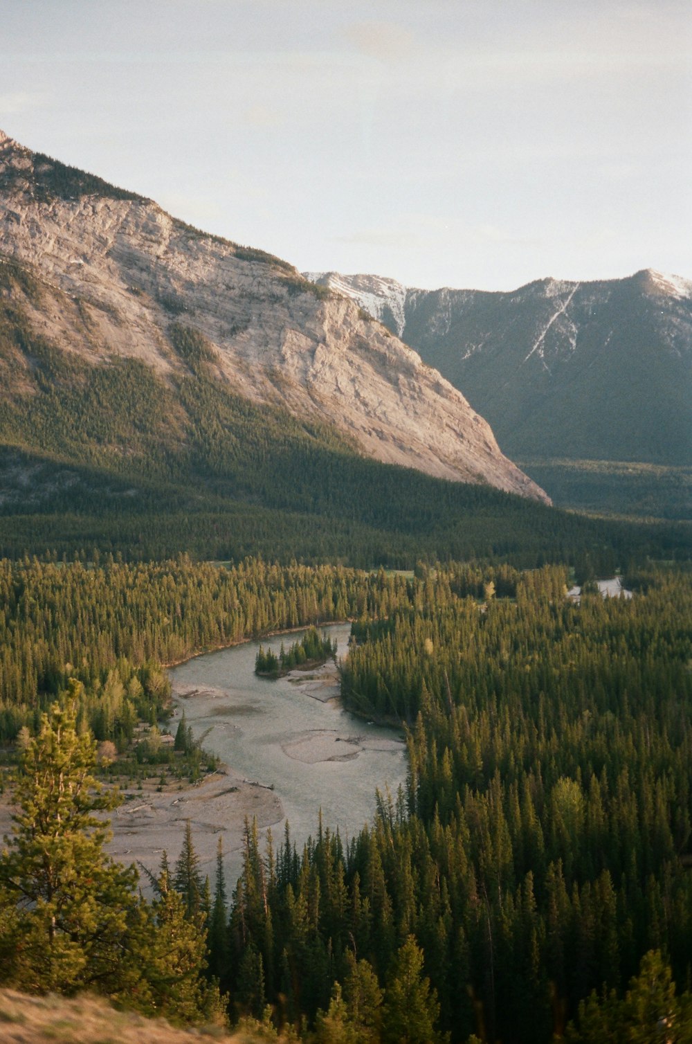 a river running through a valley between mountains