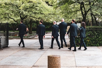 a group of people walking on a sidewalk