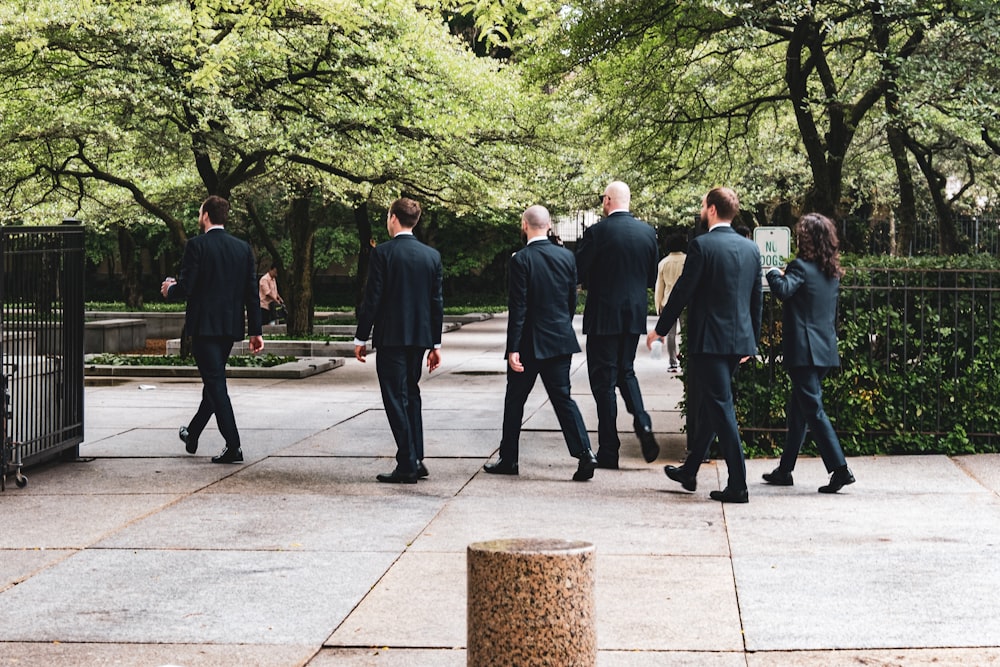 a group of people walking on a sidewalk