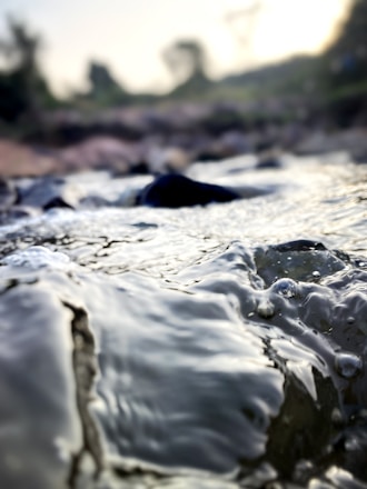 Close-up of clear water flowing through industrial filtration equipment.