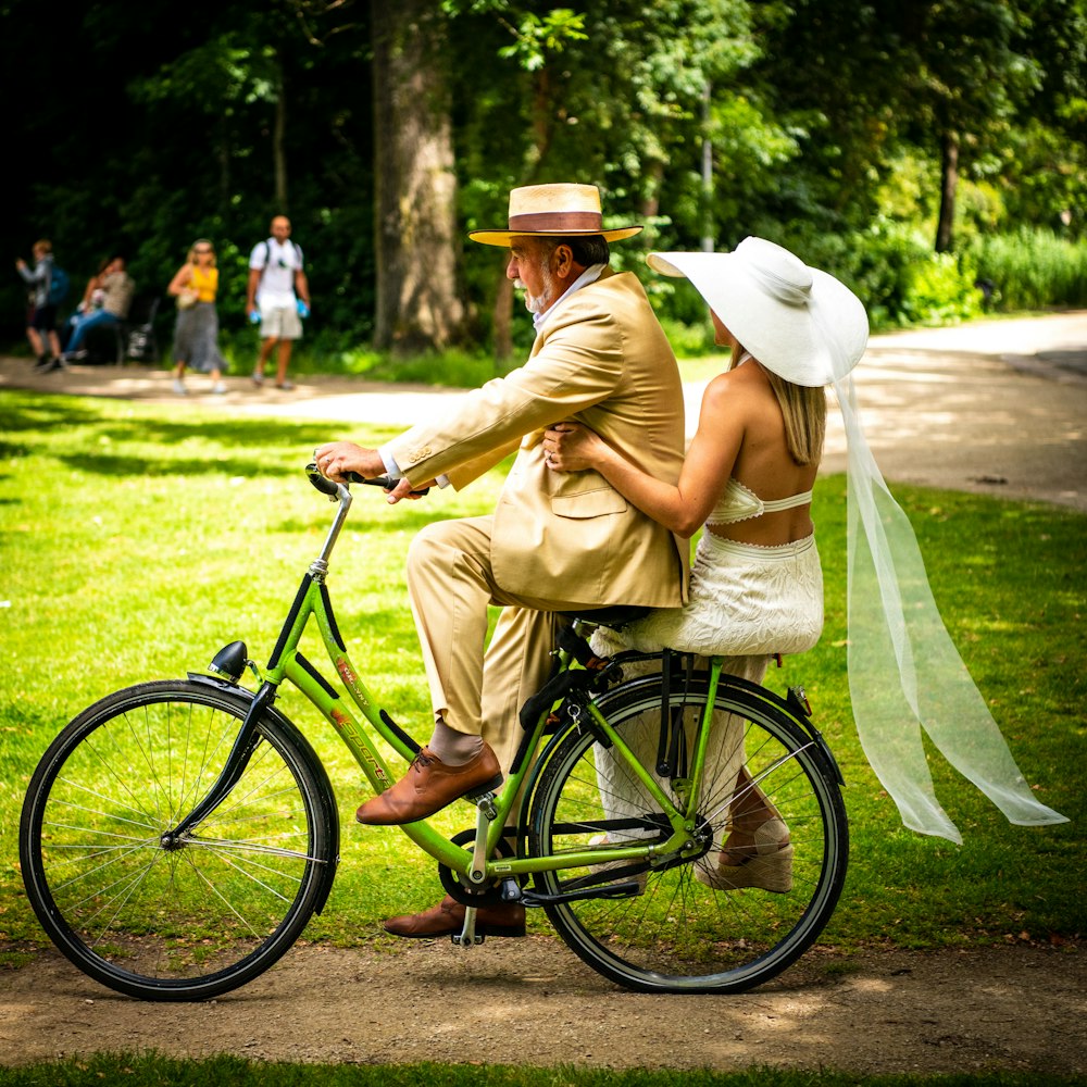 a man and woman riding a bicycle
