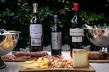An inviting tasting table set outdoors with bottles from various world regions and tasting notes.