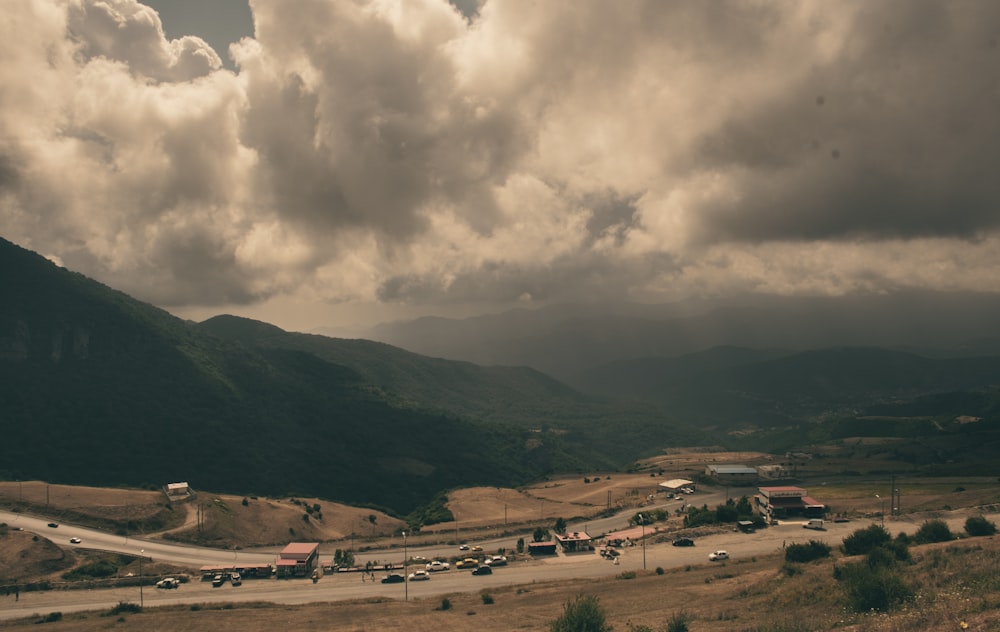 a landscape with hills and cars