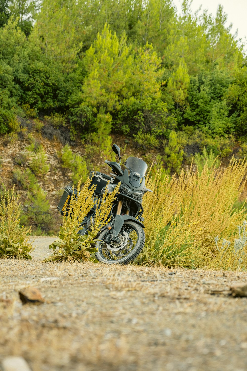 a motorcycle parked on a dirt road