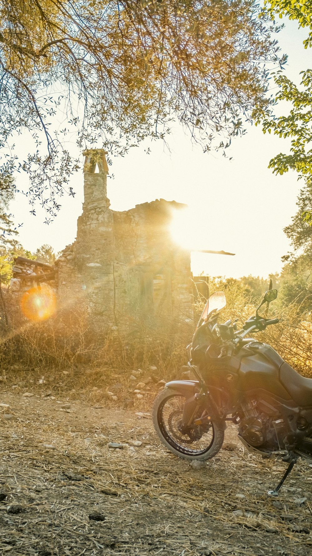 a motorcycle parked in front of a stone structure