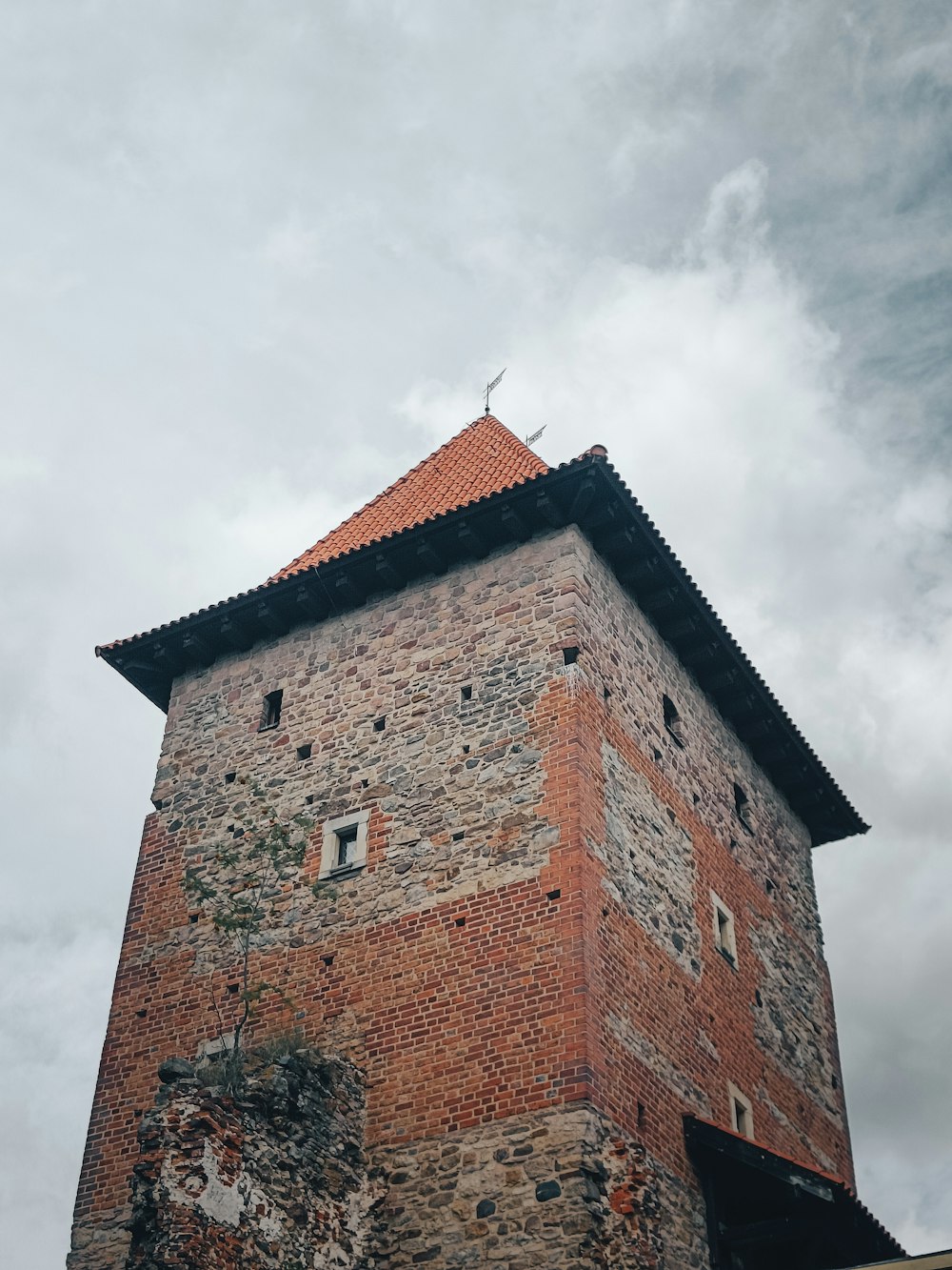 a brick tower with a cross on top