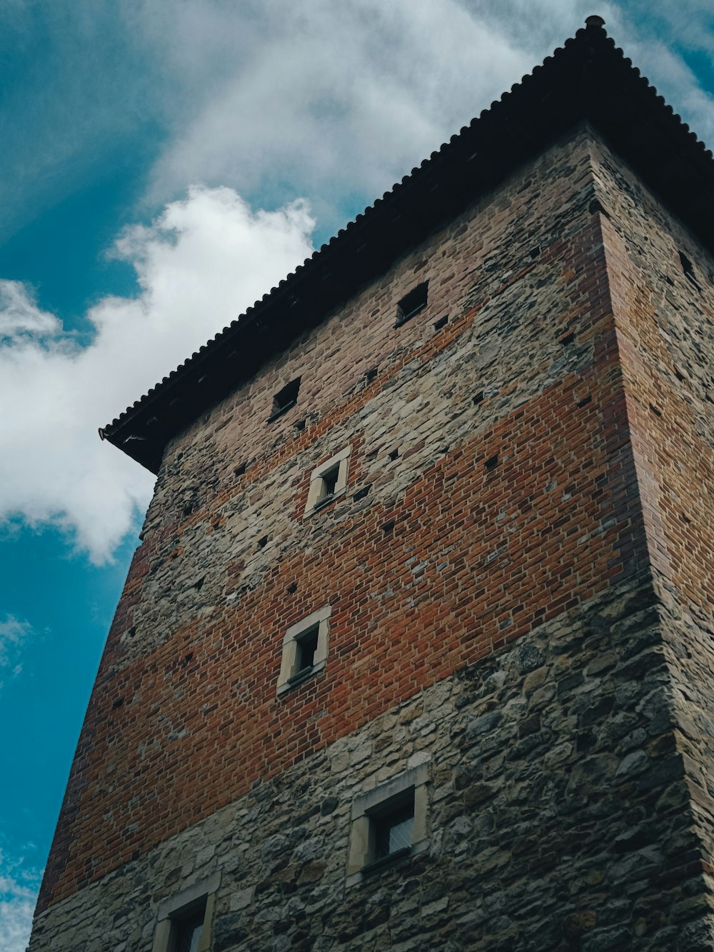 a brick building with a blue sky