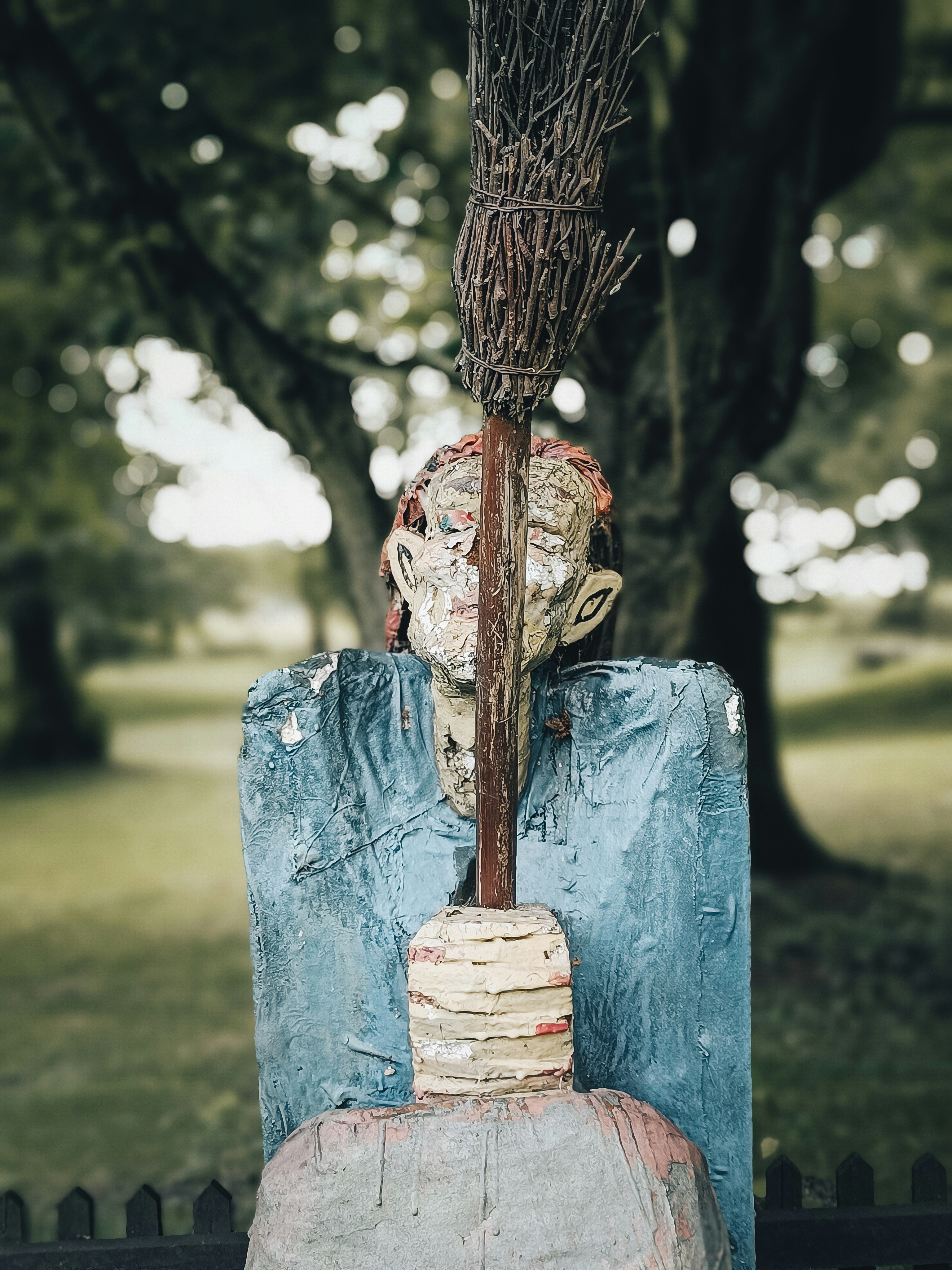 a water fountain with a tree in the background