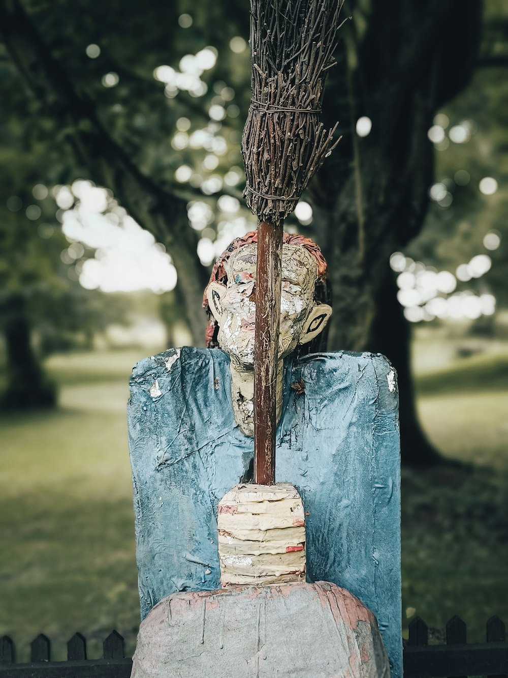 a water fountain with a tree in the background