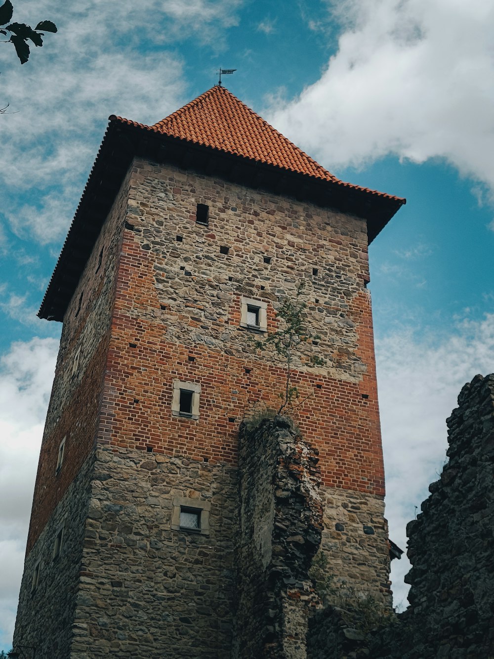 a brick tower with a cross on top