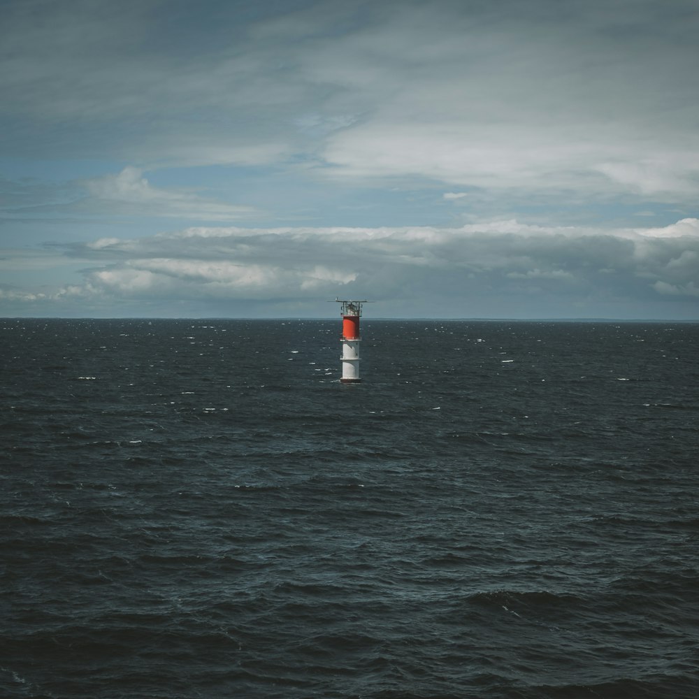 a lighthouse in the middle of the ocean