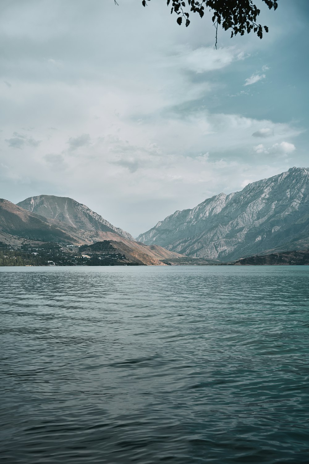 a body of water with mountains in the background