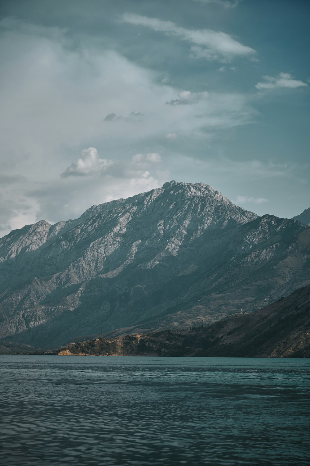 a body of water with a mountain in the background