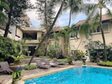 A tranquil pool area surrounded by tropical plants and flowers.