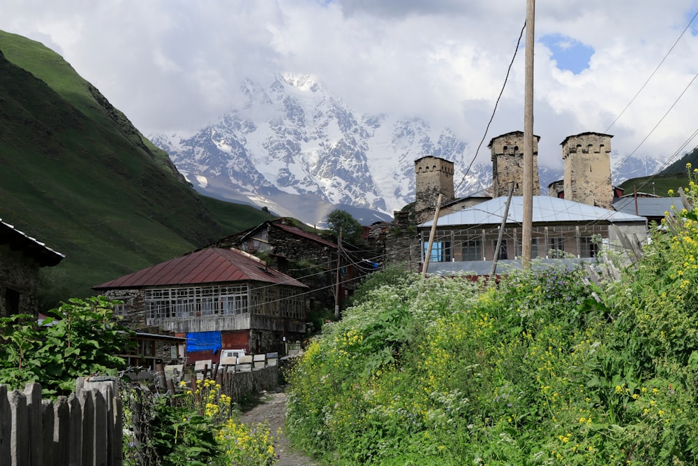 a building with a tower and a mountain in the background