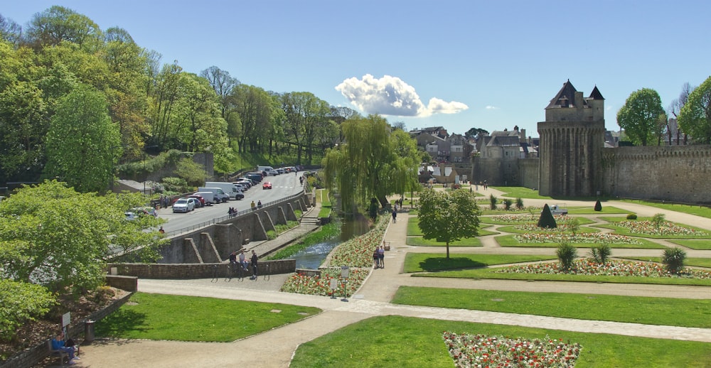 a castle with a parking lot and cars parked in front