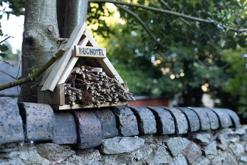 a bird house on a stone wall