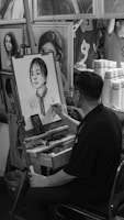An artist at work sketching a portrait from a live model in the studio.