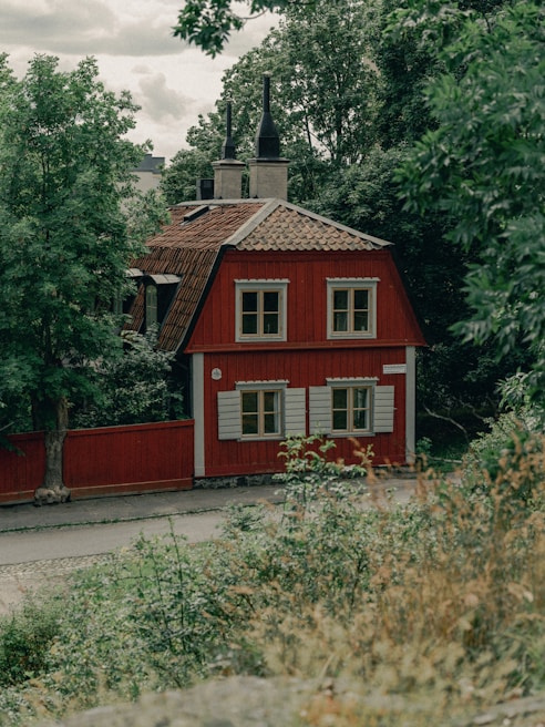 a house with bushes in front of a building